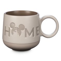 a ceramic mug with mickey mouse's head and the word home printed on it