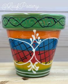 there is a colorful pot with designs on it