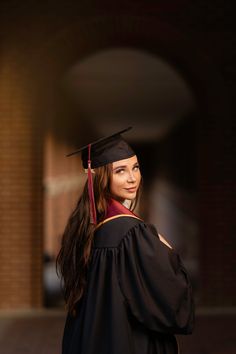 a woman wearing a graduation gown and cap