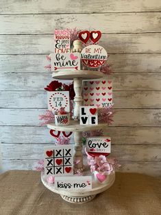 a tiered cake with valentine's day decorations on it