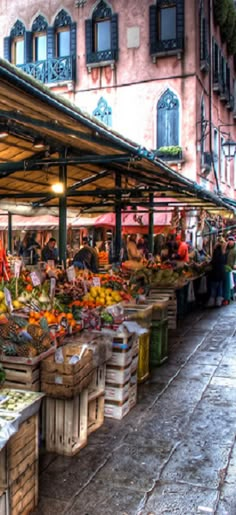 an outdoor market with lots of fruits and vegetables