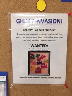 a sign posted on the wall in front of a bulletin board that says, ghost invision