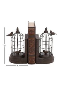 a bookend with two birds in it and a birdcage on the top