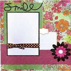 a scrapbook page with flowers and a bow on the front, along with an empty notepad