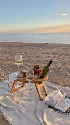 a bottle of wine sitting on top of a table next to a glass of wine