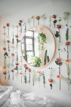 a mirror and some plants on a wall