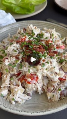 a plate full of food with lettuce and tomatoes