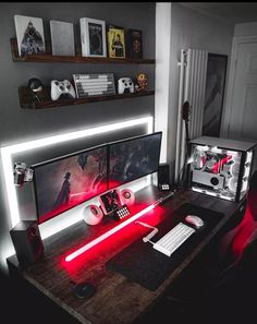 a computer desk with two monitors, keyboard and mouse on it in a dark room