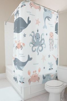 a bathroom with an octopus shower curtain next to a toilet