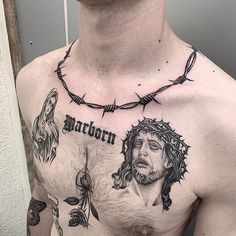 a man with tattoos on his chest has barbed wire around him and is looking at the camera