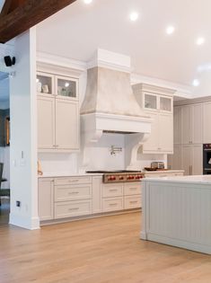 a large kitchen with white cabinets and an island