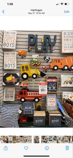 an image of a display with toy trucks and cars on the wall in front of it