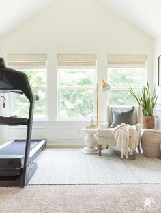 a living room with a treadmill and couch