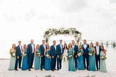 a group of people standing next to each other on a beach