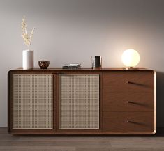 a sideboard with two drawers and a lamp on top of it next to a wall