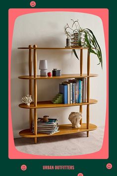 a wooden shelf with books and plants on it