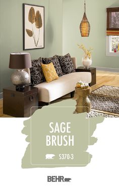 a living room with sage green paint and brown accents on the walls, along with an area rug