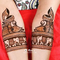 the legs are decorated with henna designs and elephants on it's sides,