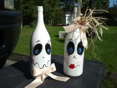 two painted wine bottles sitting on top of a table