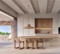 an open kitchen and dining room with stone walls