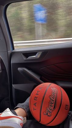 a basketball sitting in the passenger seat of a car