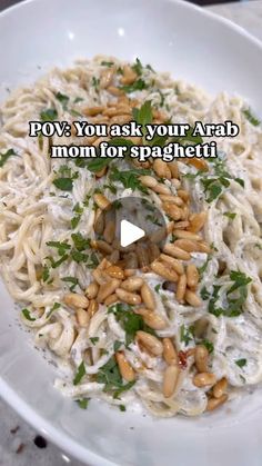 a white bowl filled with pasta and nuts