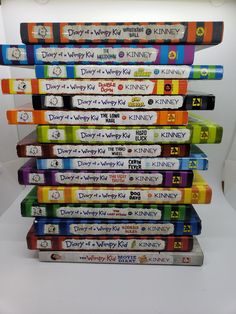 a stack of disney dvd's sitting on top of each other