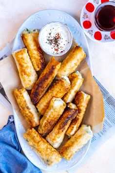 some food is sitting on a plate with dipping sauce