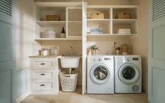 a washer and dryer in a small room with shelves on the wall behind them