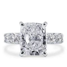 a cushion cut diamond ring with three side stones