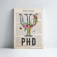 a book page with the word ph d printed on it and flowers in the middle