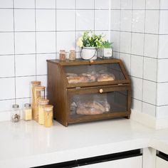 bread is sitting on top of a counter in a kitchen with white tiled walls and flooring