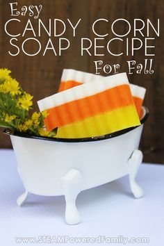 easy candy corn soap recipe for fall with flowers in the tub and text overlay that says easy candy corn soap recipe for fall