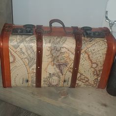 two pieces of luggage sitting on top of a wooden shelf