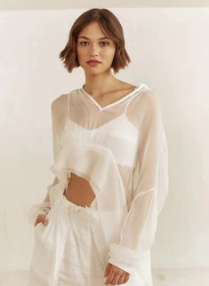 A sheer pullover crop top, made of silk chiffon designed in an easy relaxed fit. Designed with an asymmetric hem and v-neckline.FABRIC: 100% Silk ChiffonMade in the USA Pullover Crop Top, Triangle Bralette, Bra Top, Silk Chiffon, Asymmetric Hem, Resort Wear, Signature Style, Bra Tops