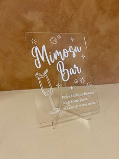 an acrylic sign that says minnesota bar with a wine glass in it on a table