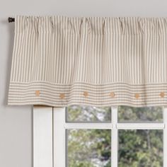 a window with a striped valance hanging on it's side