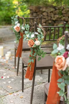 the chairs are decorated with flowers and greenery for an outdoor wedding ceremony or reception