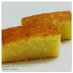 two pieces of yellow cake sitting on top of a white table