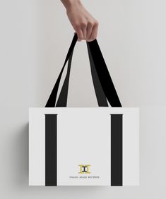 a person holding a black and white shopping bag