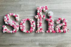 the word sale spelled with pink and white flowers