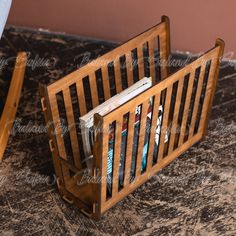 a wooden magazine rack with magazines in it