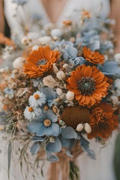 Dusty blue and burnt orange wedding bouquet    Dusty blue burnt orange wedding | dusty blue wedding | burnt orange wedding | rust orange wedding | dusty blue burnt orange wedding theme | dusty blue burnt orange wedding flowers | dusty blue burnt orange wedding ideas | wedding bouquet | fall wedding bouquet | fall wedding bouquet ideas Powder Blue And Orange Wedding, Dusty Blue And Copper Wedding Theme, Steel Blue Fall Wedding, Burnt Orange Navy Blue Color Palette, Dark Teal And Burnt Orange Wedding Flowers, Rust Orange And Dusty Blue Wedding, Teal And Orange Flowers, Burnt Orange Light Blue Wedding, Teal Wedding Aesthetic