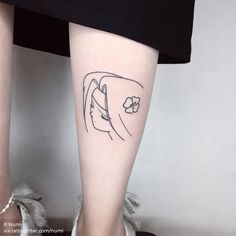 a woman's leg with a small tattoo on the left side of her body