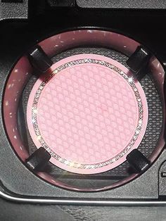 the inside of a car's steering wheel cover with pink and black circles on it