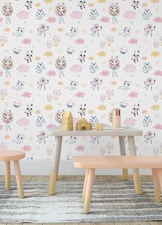 two children's wooden benches in front of a colorful wallpaper