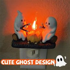 three ghost figurines sitting on top of a light switch with the words cute ghost design