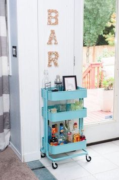 a blue cart sitting in the corner of a room next to a door with a sign on it