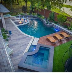 a backyard with a swimming pool and fire pit