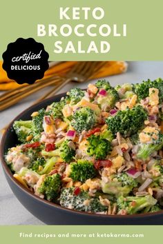 a bowl filled with broccoli and other food on top of a table next to utensils